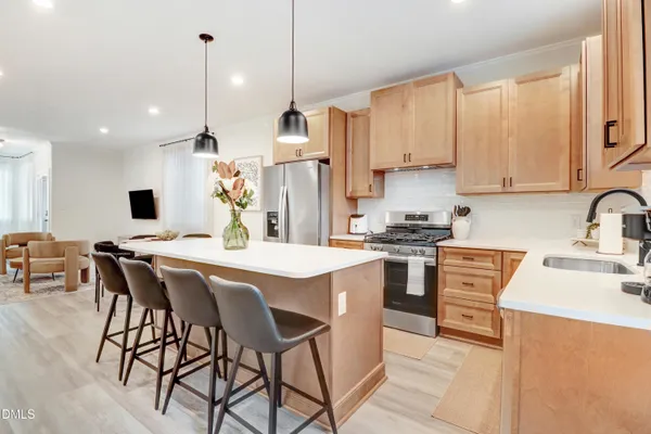 a kitchen with a stove a sink and a refrigerator