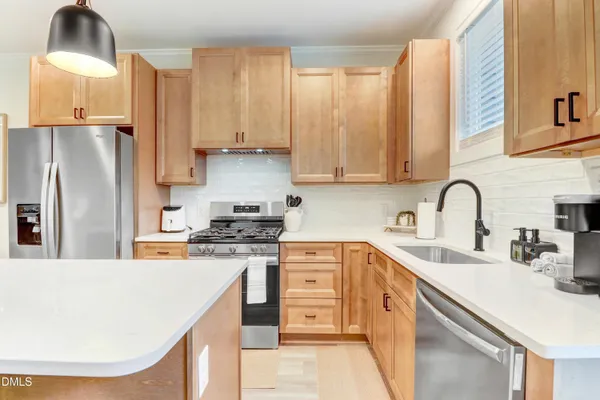 a kitchen with a table chairs and wooden floor