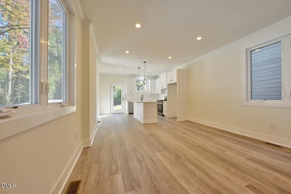 a view of a kitchen with wooden floor and windows