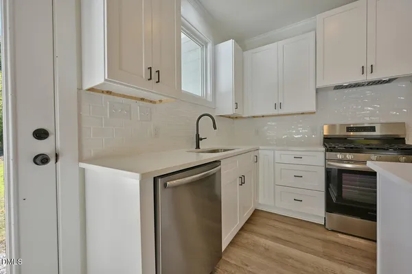 a kitchen with appliances cabinets and a sink