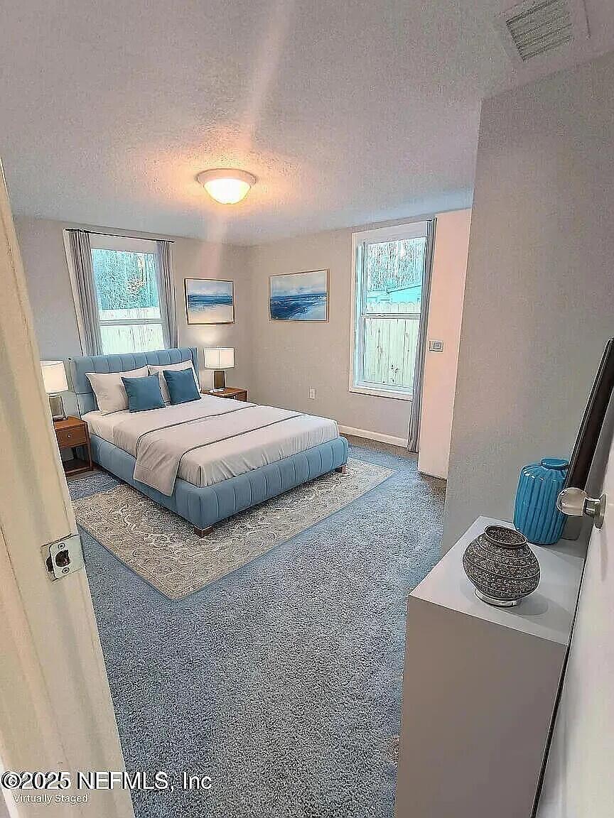 9420 Joos Road Jacksonville, FL 32220 - Photo 3 of 9 a bedroom with a bed and a dresser in it