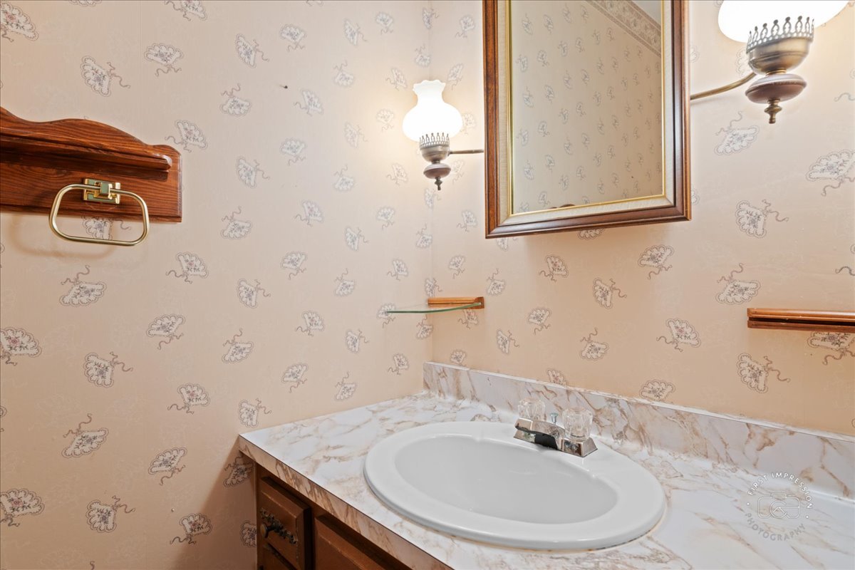 6N400 Old Homestead Road St. Charles, IL 60175 - Photo 17 of 32 a bathroom with a sink and a mirror