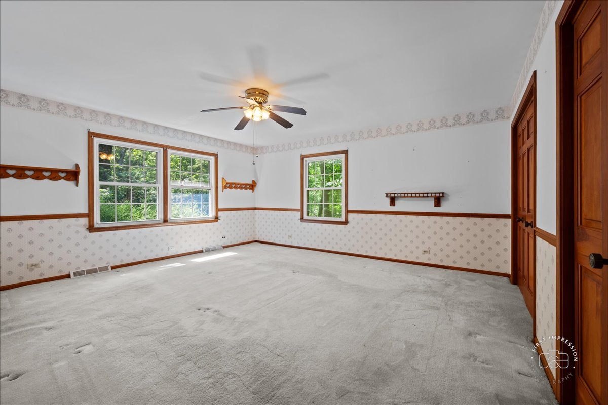 6N400 Old Homestead Road St. Charles, IL 60175 - Photo 19 of 32 an empty room with windows and ceiling fan