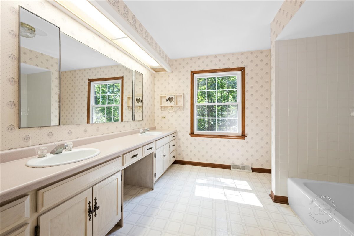 6N400 Old Homestead Road St. Charles, IL 60175 - Photo 26 of 32 a spacious bathroom with a tub sink and mirror