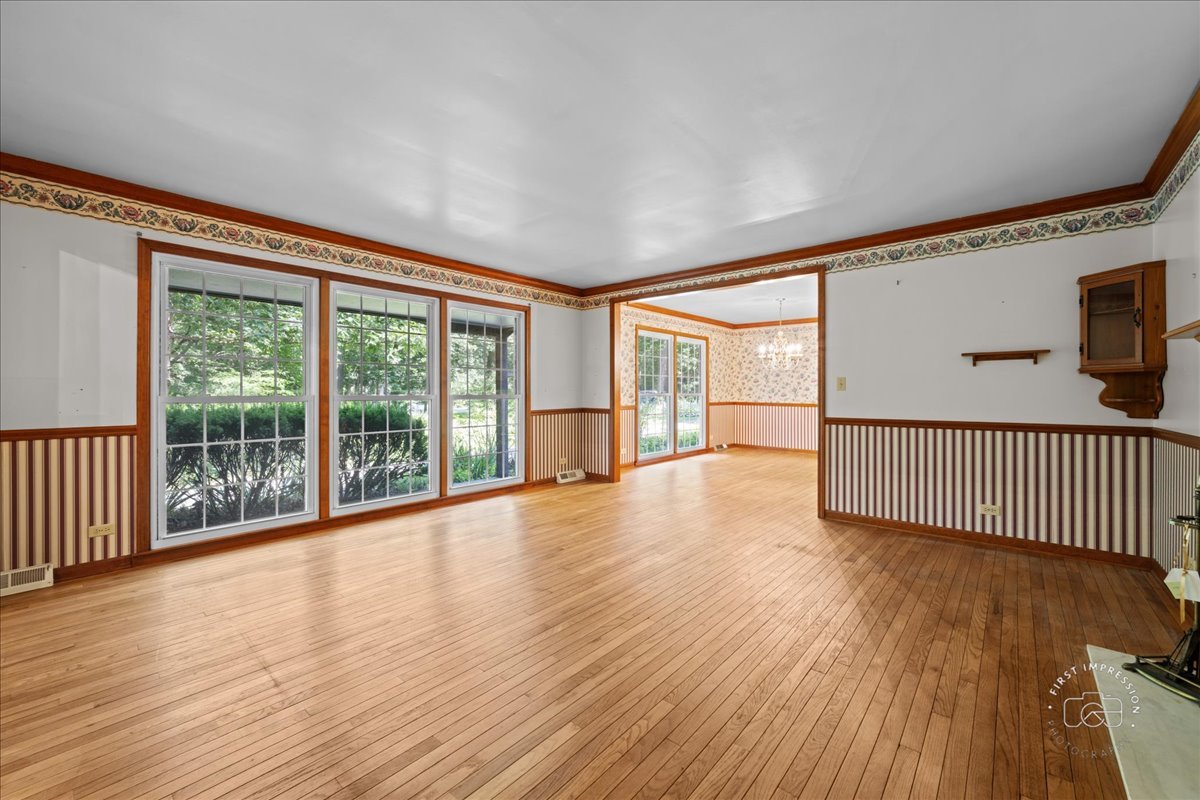 6N400 Old Homestead Road St. Charles, IL 60175 - Photo 7 of 32 a view of an empty room with wooden floor and a window