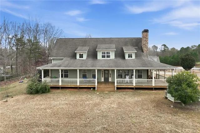a view of a house with a yard and sitting area