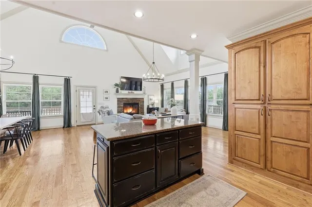 a bedroom with a large bed and a chandelier