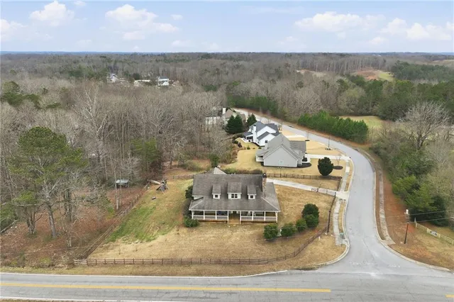 an aerial view of a house with a yard