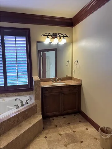 a view of a livingroom with wooden floor and a ceiling fan