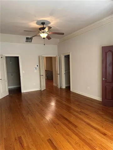 a view of a room with wooden floor