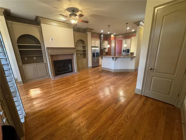a open kitchen view with fireplace and wooden floor