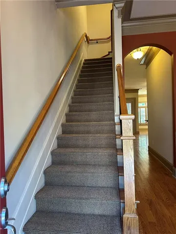 a view of entryway and hall with wooden floor