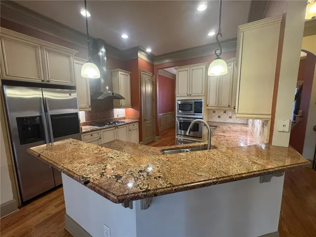 a kitchen with granite countertop a stove and a sink