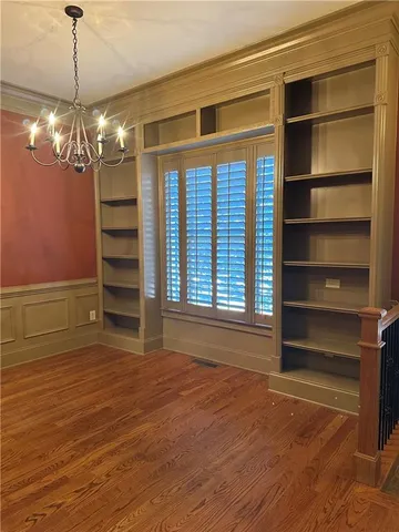 a view of a room with a large window and chandelier