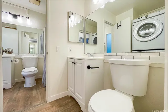 a white toilet sitting next to a bathroom sink