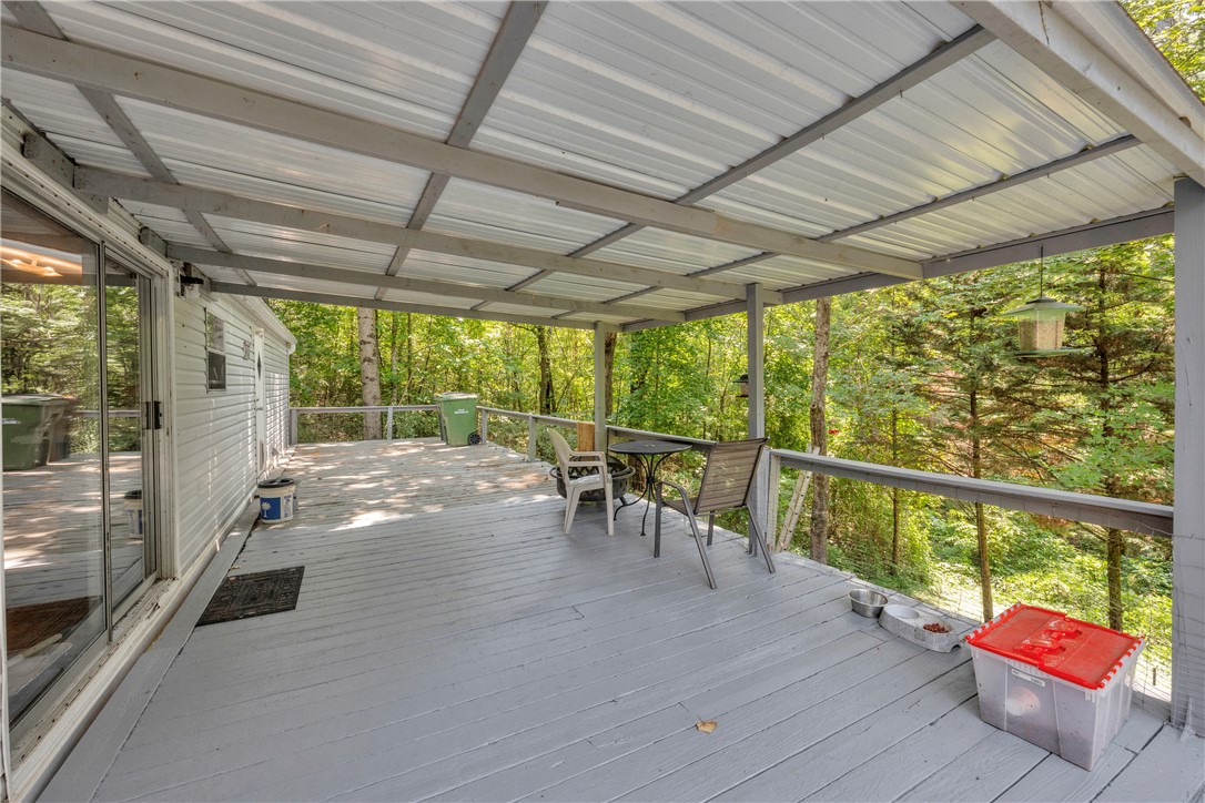 162 Newberry Road Walhalla, SC 29691 - Photo 31 of 50 Enjoy nature's embrace from this generous covered deck, perfect for peaceful outdoor moments.