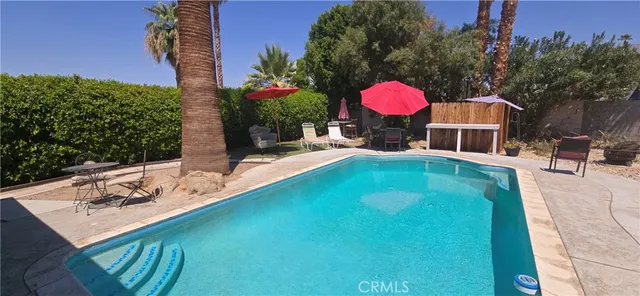 a view of a swimming pool with a lounge chairs