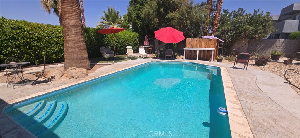 44470 San Pablo Avenue Palm Desert, CA 92260 - Photo 16 of 17 a view of a swimming pool with a lounge chairs