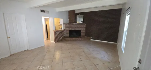 a view of a livingroom with an empty space and a fireplace