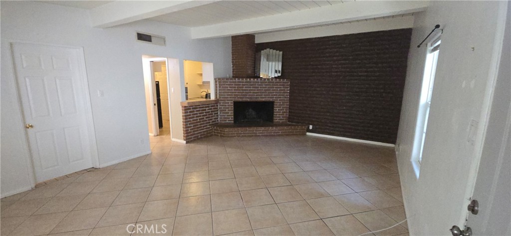 44470 San Pablo Avenue Palm Desert, CA 92260 - Photo 3 of 17 a view of a livingroom with an empty space and a fireplace