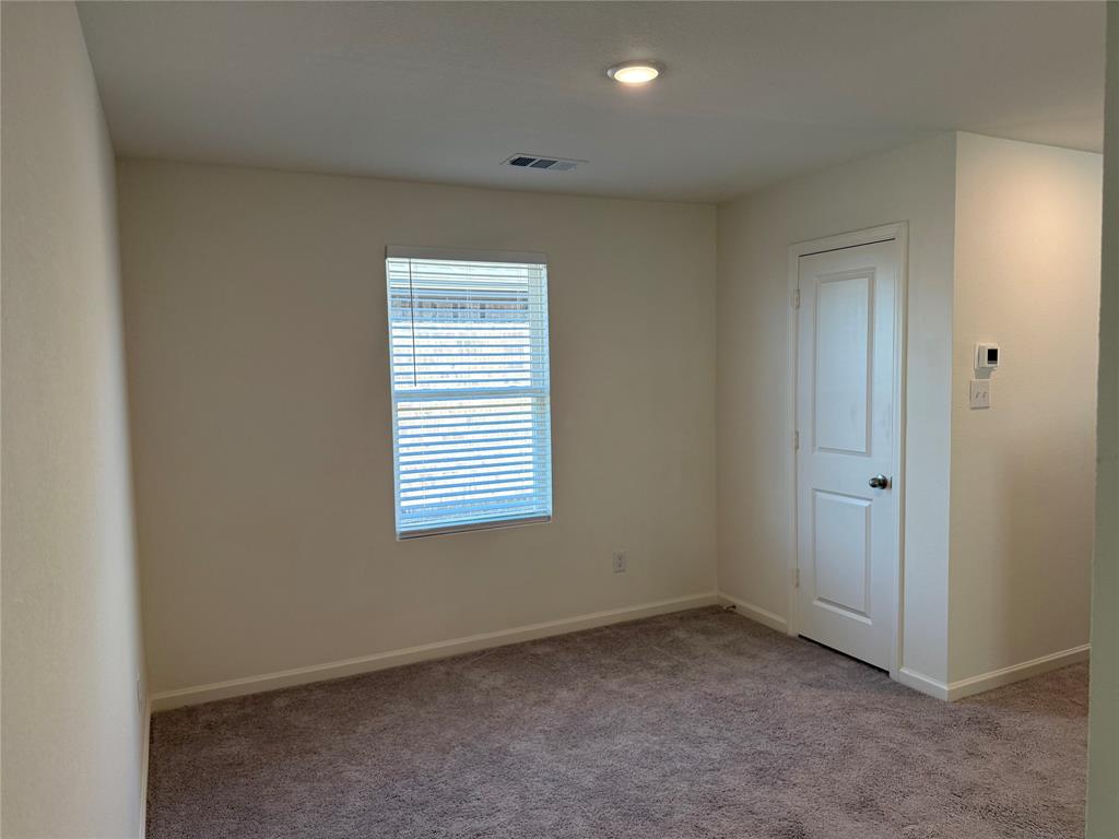 2104 Jackson Street Princeton, TX 75407 - Photo 10 of 15 an empty room with a window