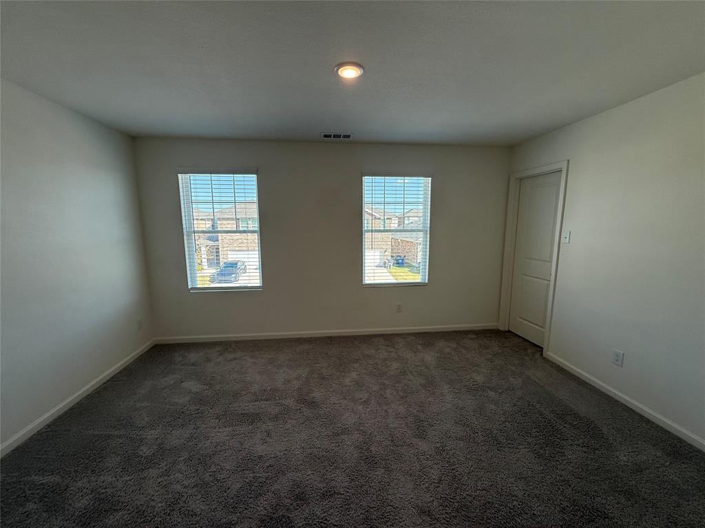 2104 Jackson Street Princeton, TX 75407 - Photo 5 of 15 an empty room with windows