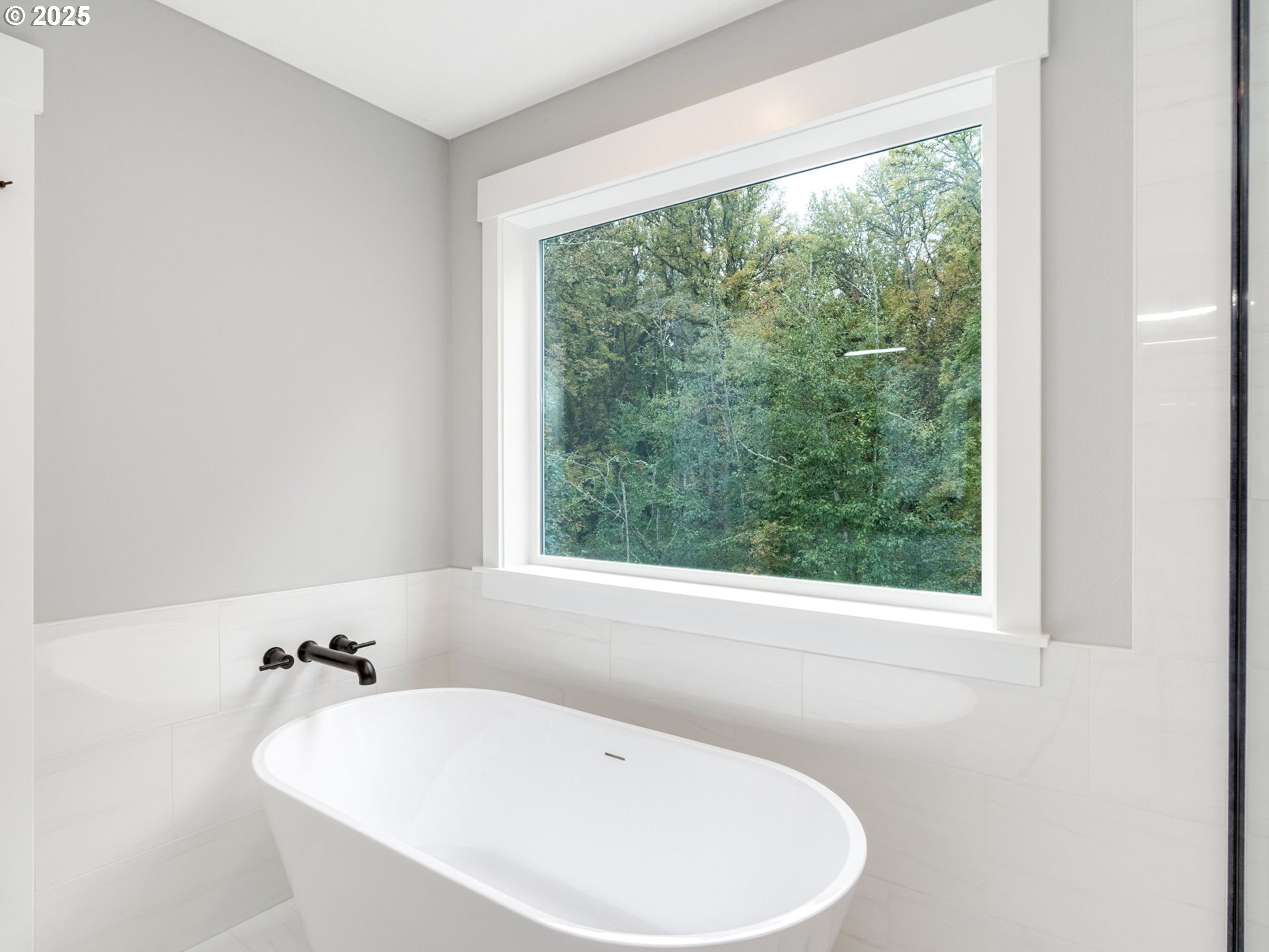 351 South 39th Drive Ridgefield, WA 98642 - Photo 25 of 44 a white bath tub sitting in a bathroom next to a window