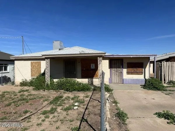 a front view of a house with a garden and pathway