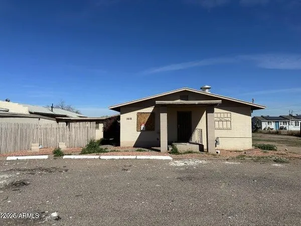 a view of a wooden house with a yard