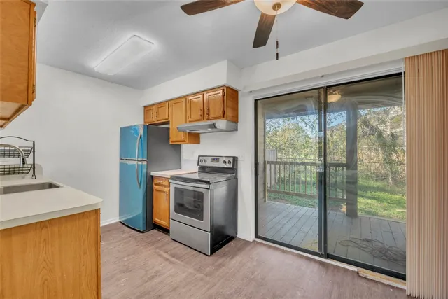 a kitchen with stainless steel appliances granite countertop a stove a sink and a refrigerator