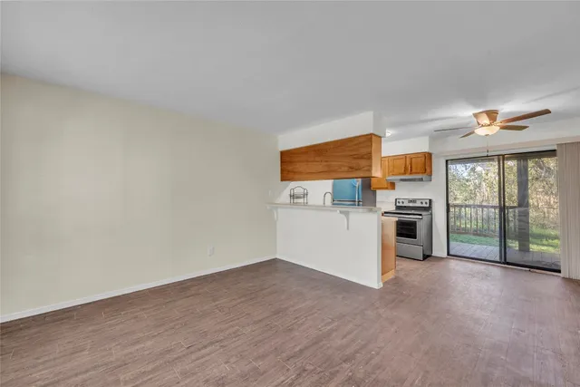 a view of a kitchen with refrigerator and windows