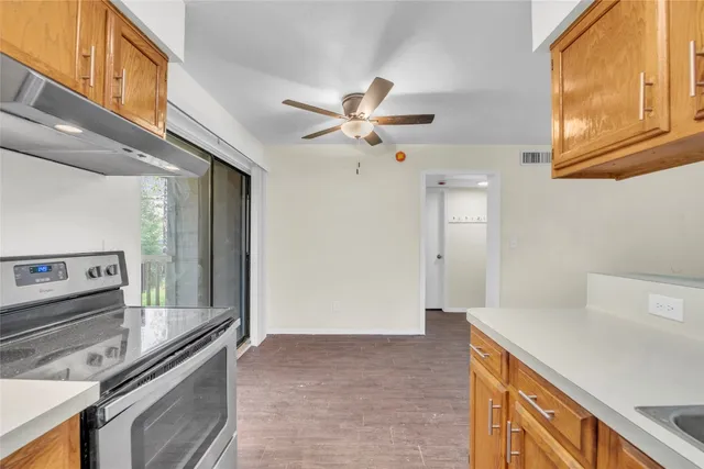 a kitchen with stainless steel appliances a stove a sink and a refrigerator