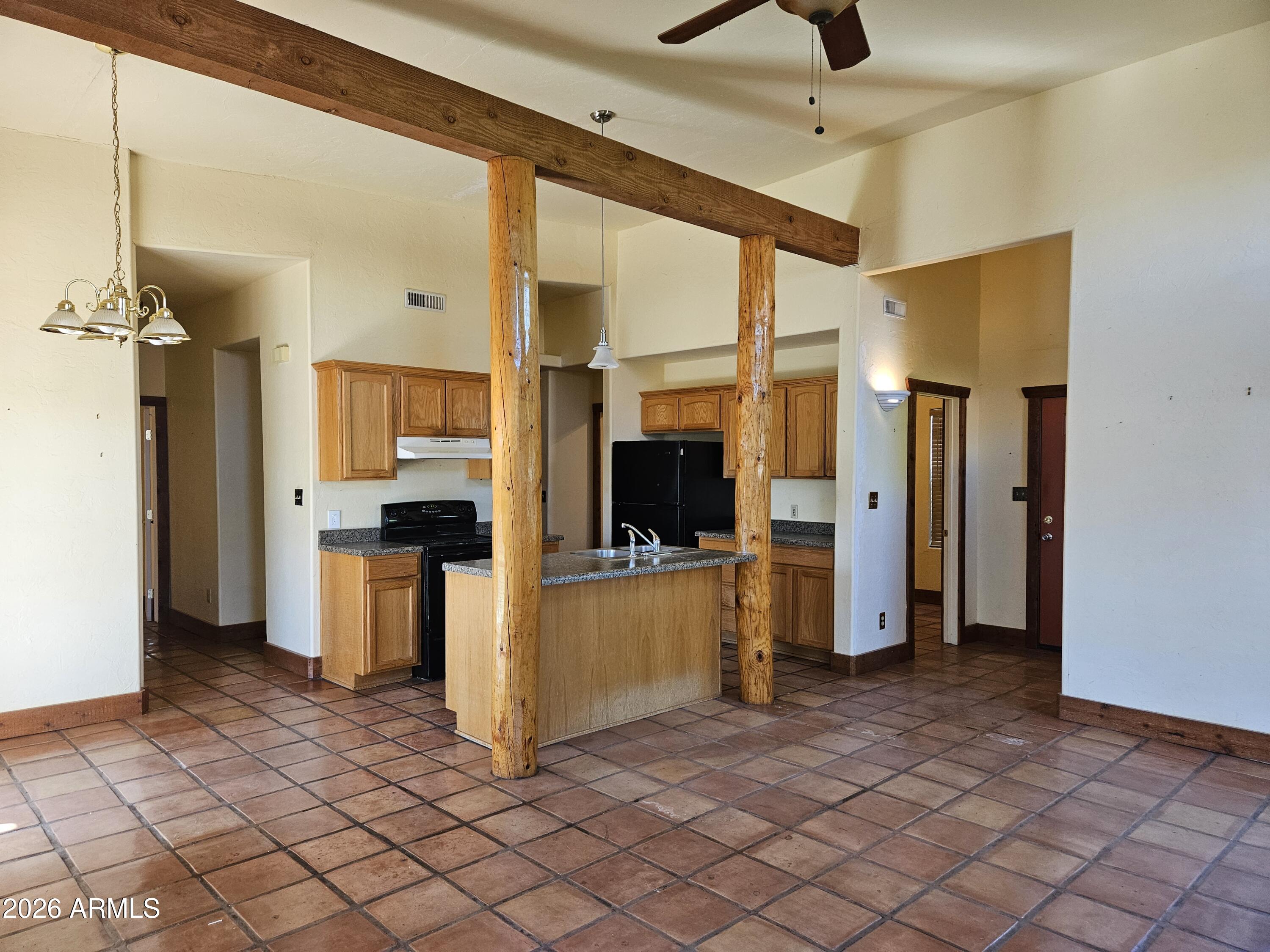 4105 North Washington Avenue Douglas, AZ 85607 - Photo 9 of 61 a kitchen with a refrigerator and a counter