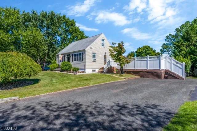 a view of a house with backyard and a garden