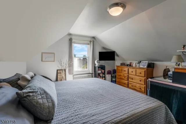 a bedroom with a bed and a television in it