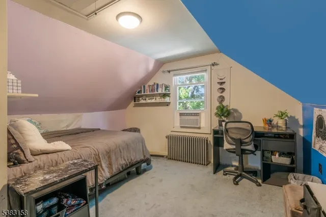 a bedroom with a bed and a desk