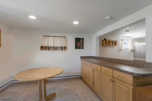 a bathroom with a granite countertop sink a toilet a mirror and vanity