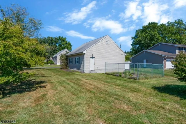 a view of an house with backyard space and garden