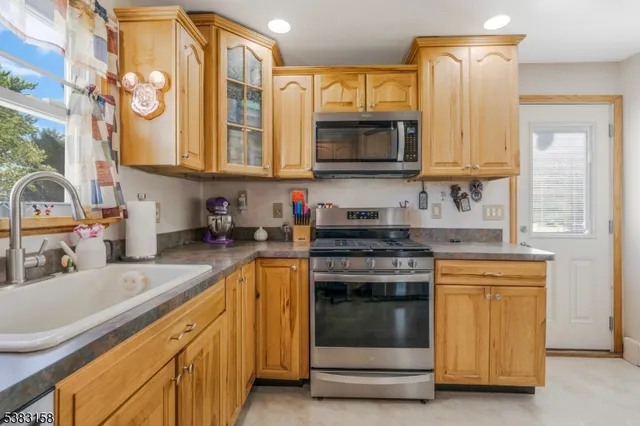 a kitchen with stainless steel appliances granite countertop a sink and a stove