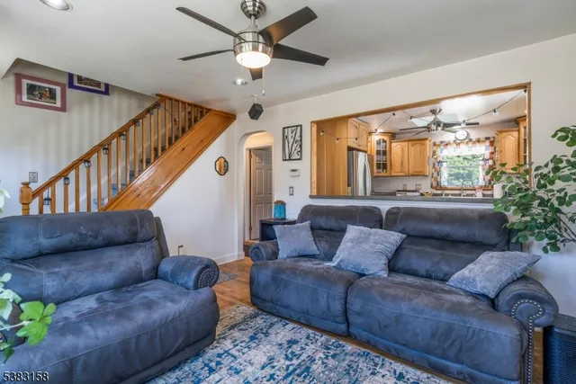 a living room with furniture and a ceiling fan