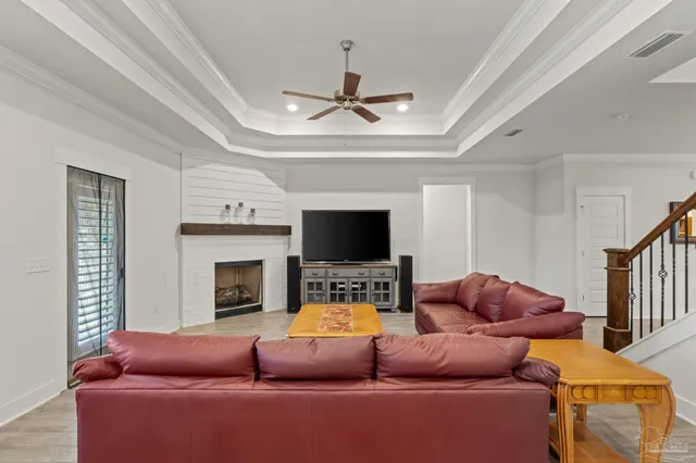a living room with furniture a flat screen tv and a fireplace