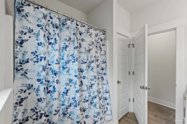 a living room with furniture and a view of kitchen