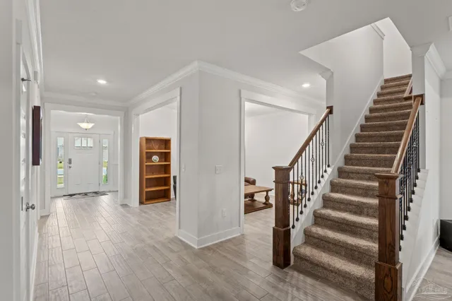 a view of a hallway with wooden floor and entryway