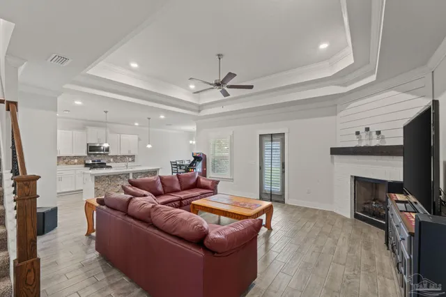 a living room with furniture a fireplace and a flat screen tv