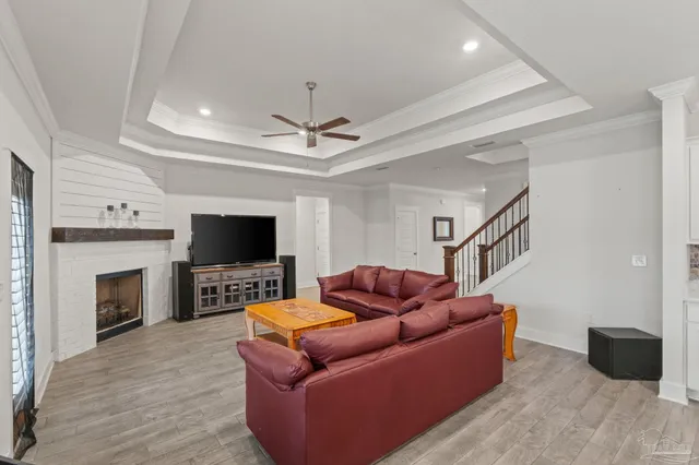 a living room with furniture a flat screen tv and a fireplace