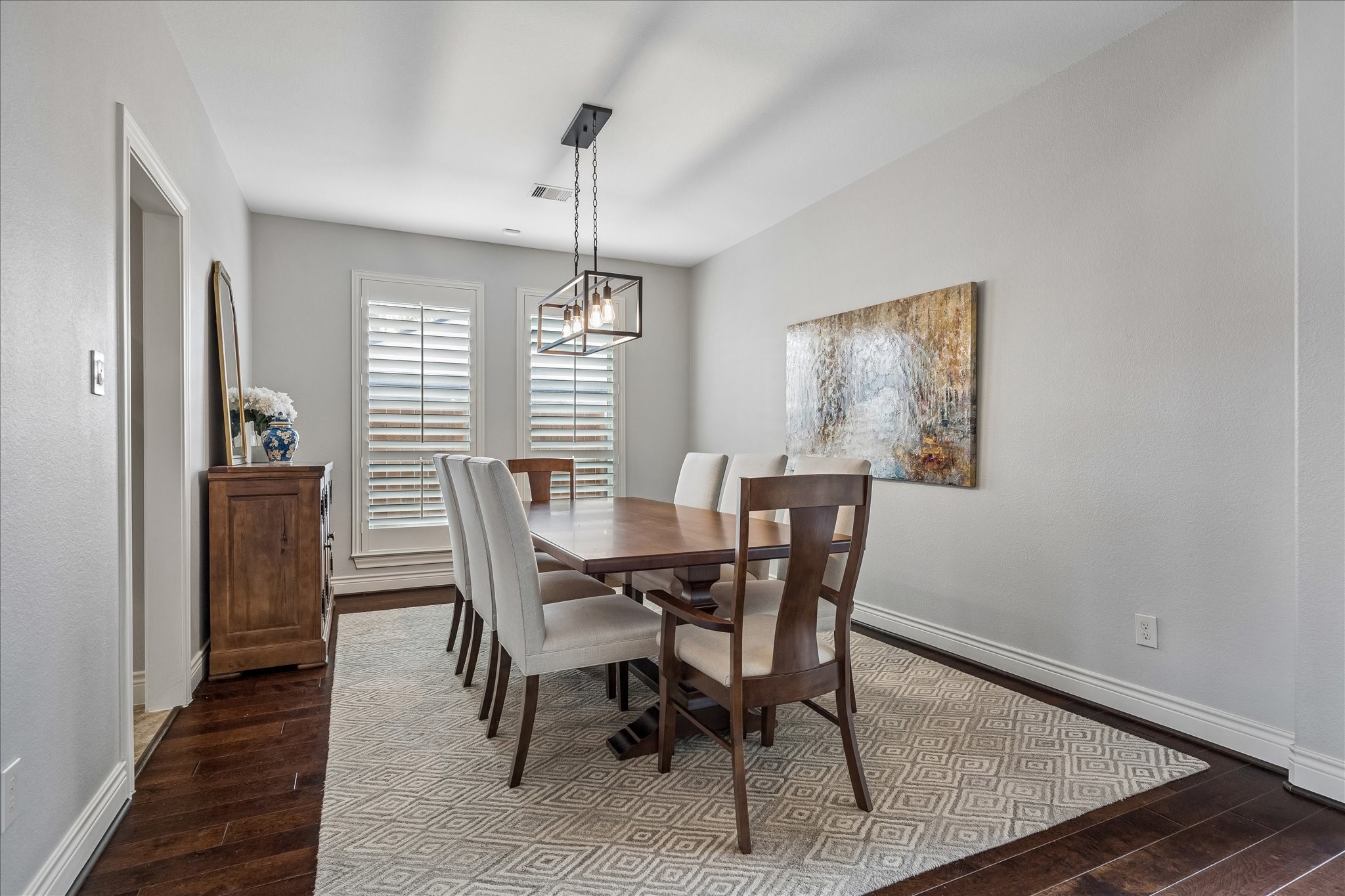 1616 Hewitt Drive Houston, TX 77018 - Photo 5 of 44 Formal dining room provides an elegant space for hosting, highlighted by a modern chandelier, oversized window with plantation shutters, and ample room for a full size dining table.