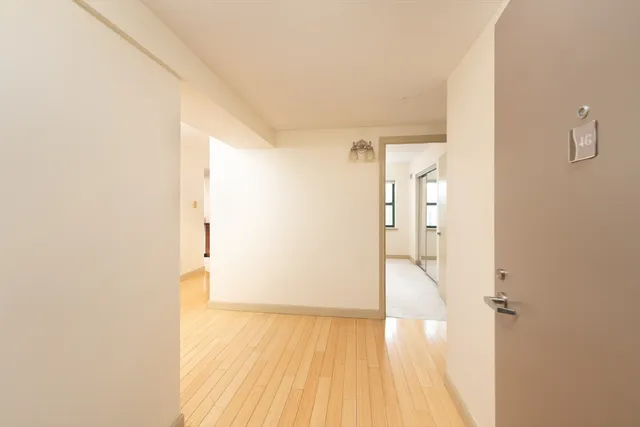 a view of a hallway with wooden floor