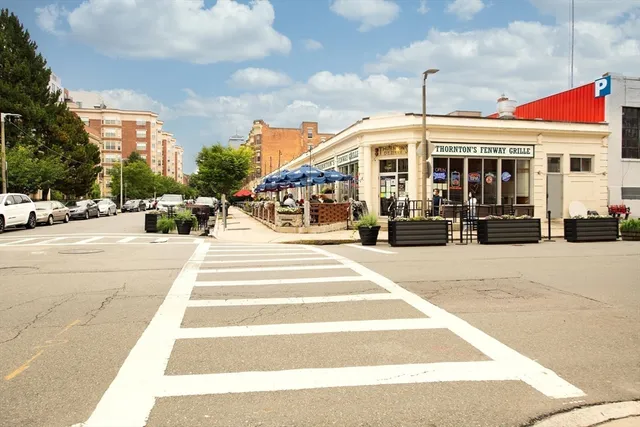 a front view of a building with a garden