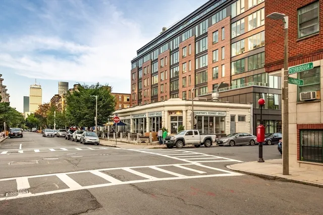 a buildings with car parked in front of it