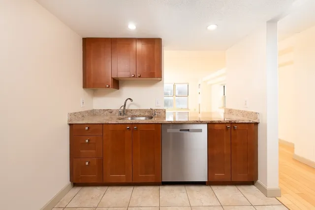 a kitchen with stainless steel appliances granite countertop a sink and cabinets